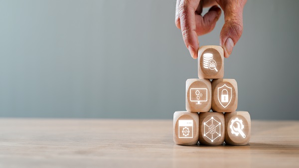 Building Blocks of Platform as a Service (PaaS) Concept with Hand Stacking Wooden Cubes