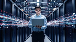 Data Center Chief Technology Officer Holding Laptop, Standing In Warehouse, Information Digitalization Lines Streaming Through Servers. SAAS, Cloud Computing, Web Service