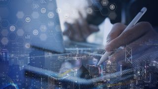 Technology professional working with a digital interface overlaid on a cityscape, representing application performance testing, software scalability, system responsiveness, and identifying performance bottlenecks before production